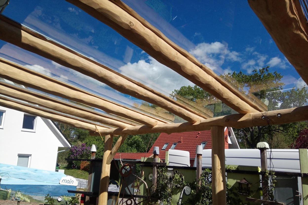 Terrassenüberdachung nach Maß Terrassenüberdachung mit Holzbalken und Glaselementen